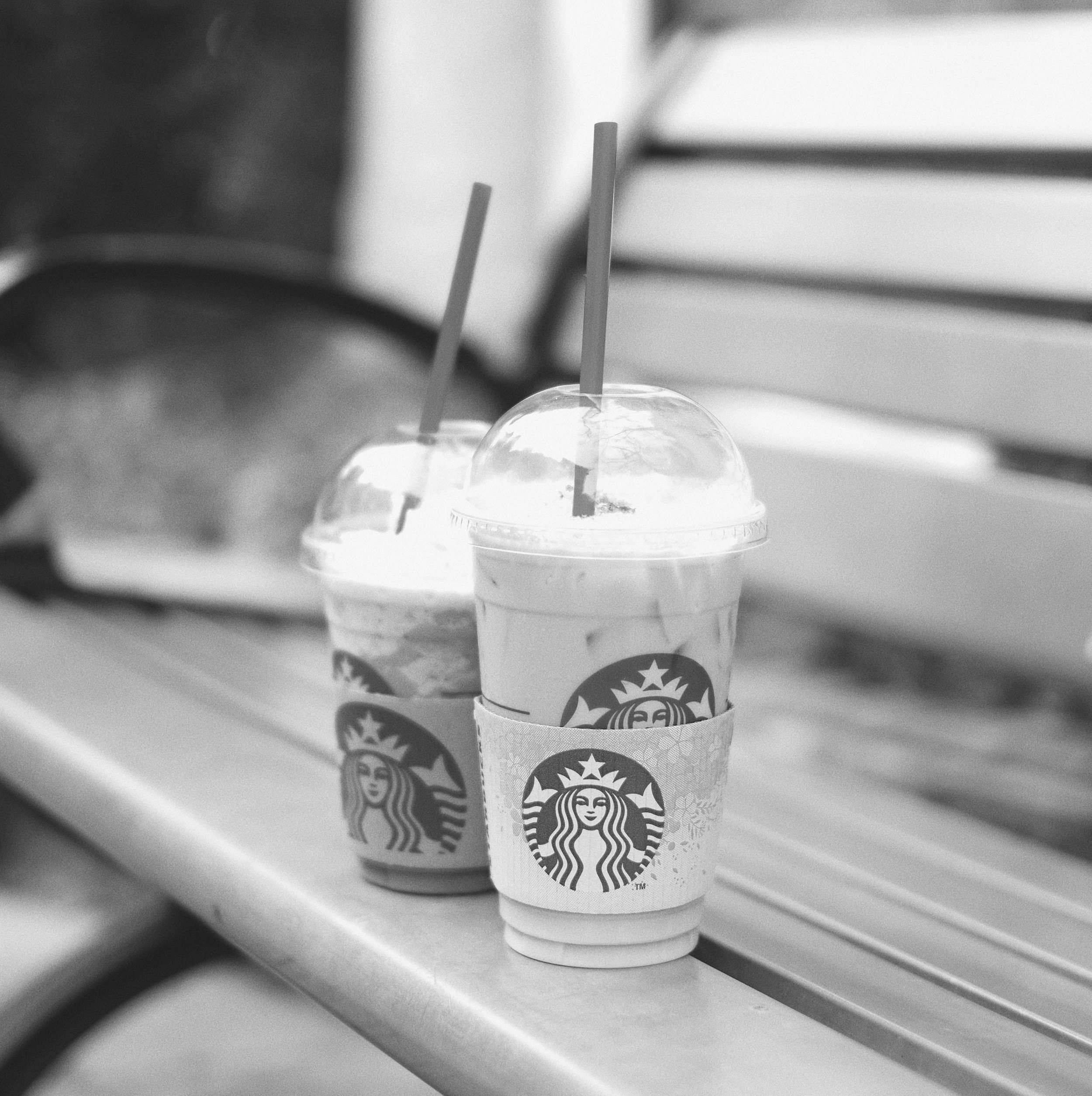 Starbucks iced drinks on a bench