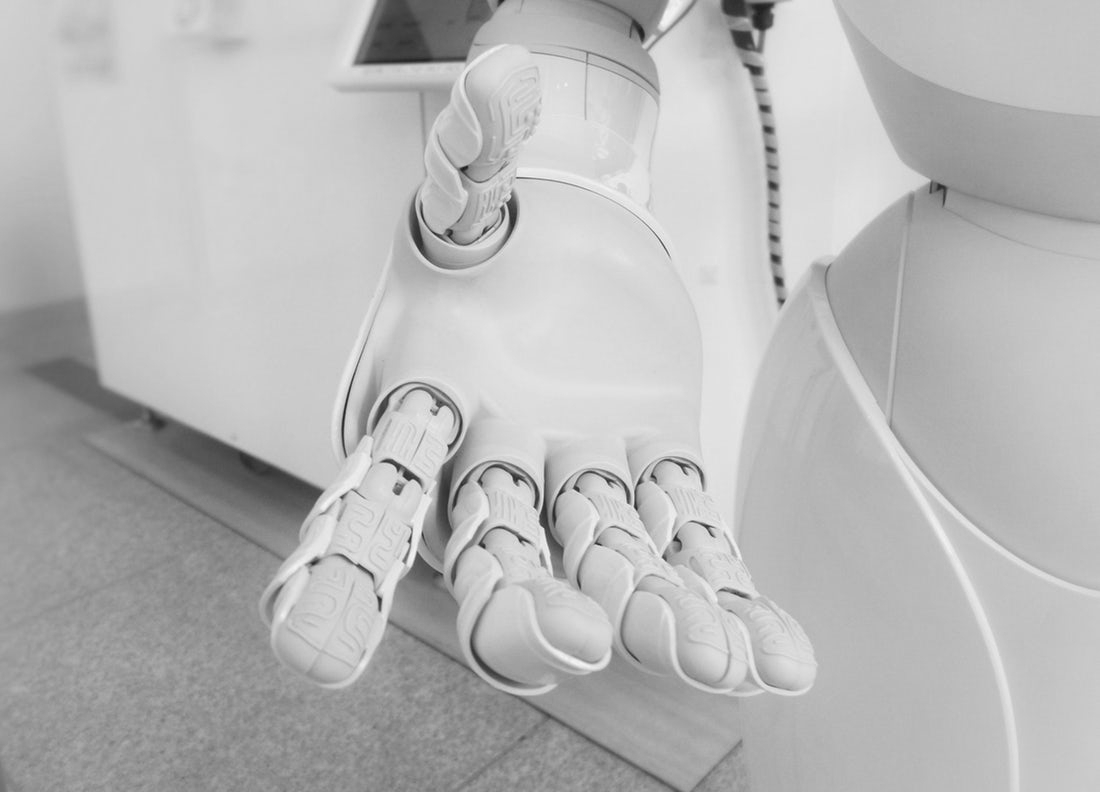 A robot hand reaching out towards the camera