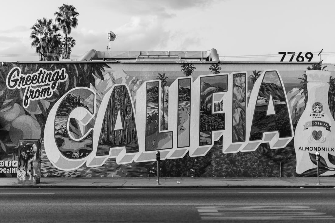A wall graffiti-d with the words “Greetings from Califia”