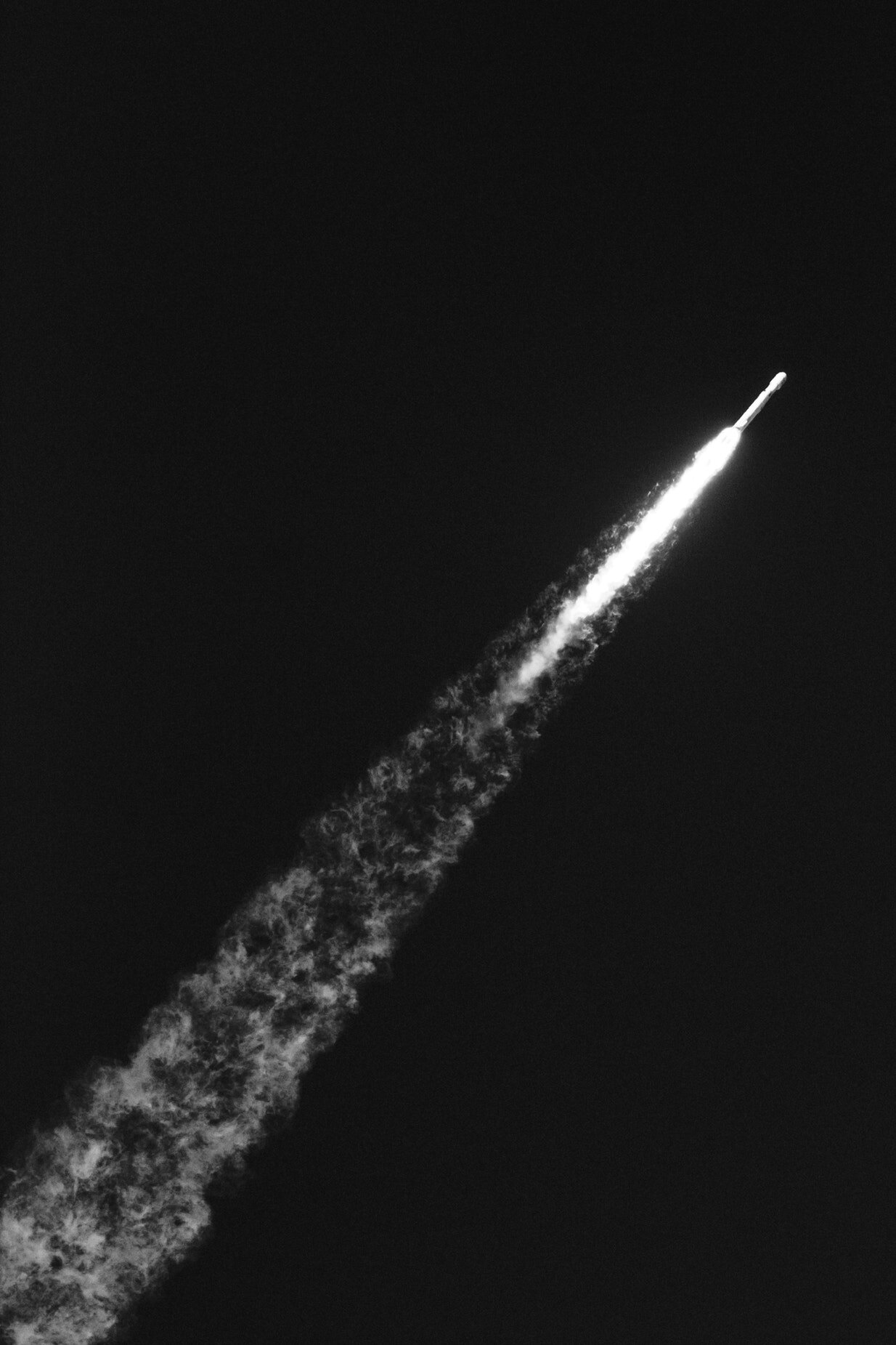 A rocket flies through the night sky