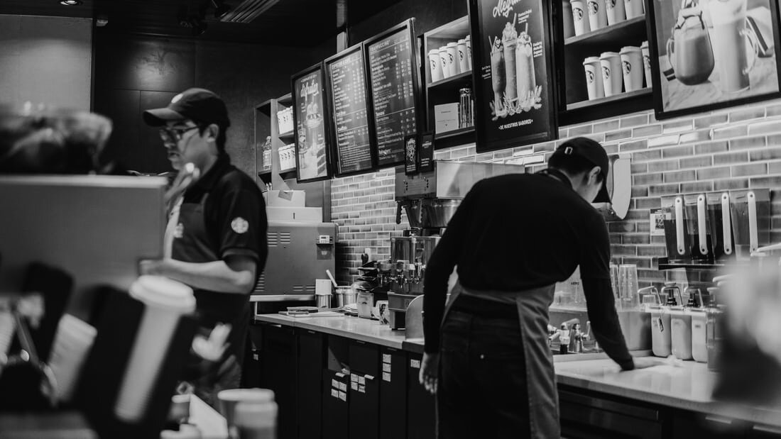 Baristas working behind the bar at a Starbucks cafe