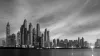 A photo of Dubai's skyline at sunset in black and white