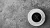 A cup of black coffee on a stone surface seen from above, with the X logo superimposed on top