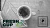 A Chemex pouring coffee into a cup on a table, seen from above, overlaid with logos for Fresh Cup Magazine and The Pourover