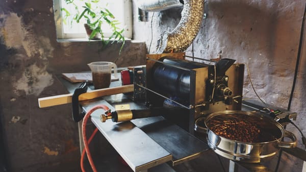 A workbench with a hand-built coffee roaster - the cooling tray is a vegetable steamer